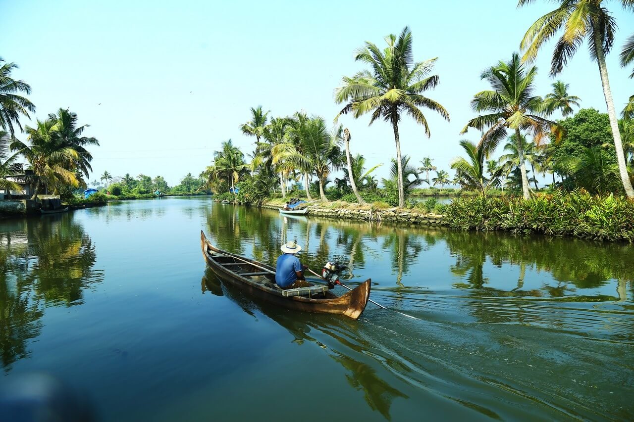 man-boat-lake-Kerala Backwaters Travel Guide